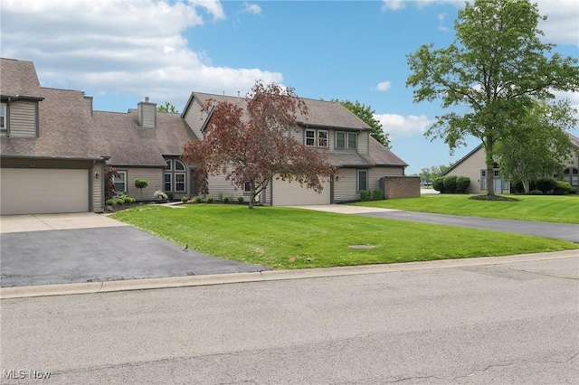 322 N Bayshore Dr Unit 3, Columbiana, OH 44408 - view of front of home featuring driveway, a front yard, and a garage