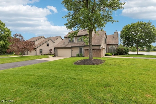 322 N Bayshore Dr Unit 3, Columbiana, OH 44408 - view of front facade featuring driveway, a front lawn, a chimney, and a water view