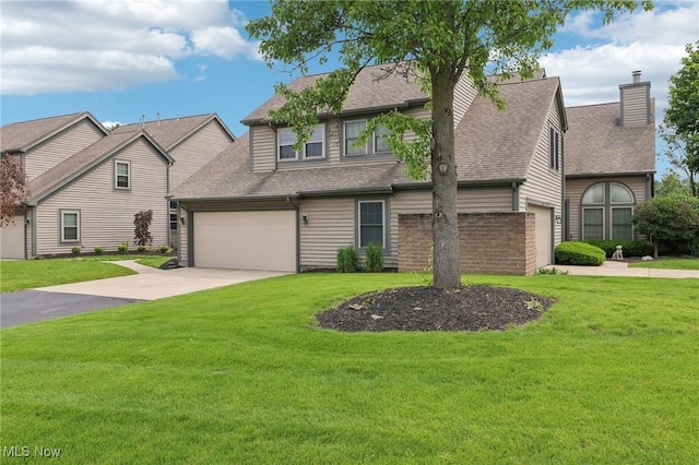322 N Bayshore Dr Unit 3, Columbiana, OH 44408 - view of front of property with roof with shingles, concrete driveway, a garage, and a chimney