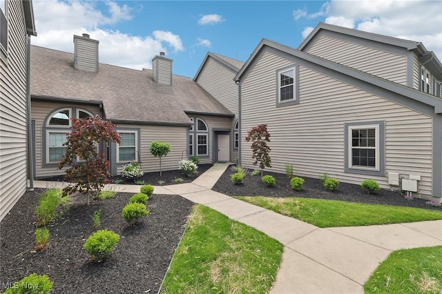 322 N Bayshore Dr Unit 3, Columbiana, OH 44408 - view of front of home featuring a chimney, a front lawn, and a shingled roof