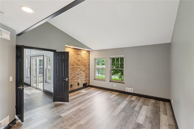 322 N Bayshore Dr Unit 3, Columbiana, OH 44408 - unfurnished living room featuring wood finished floors, baseboards, and high vaulted ceiling