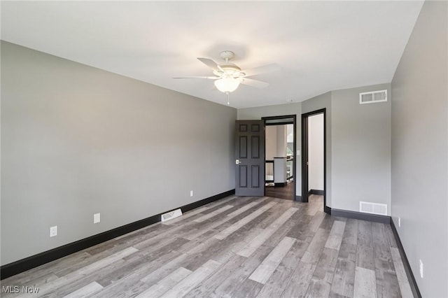 322 N Bayshore Dr Unit 3, Columbiana, OH 44408 - empty room with light wood-style flooring, a ceiling fan, and baseboards