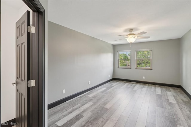 322 N Bayshore Dr Unit 3, Columbiana, OH 44408 - empty room with a ceiling fan, light wood-style floors, and baseboards