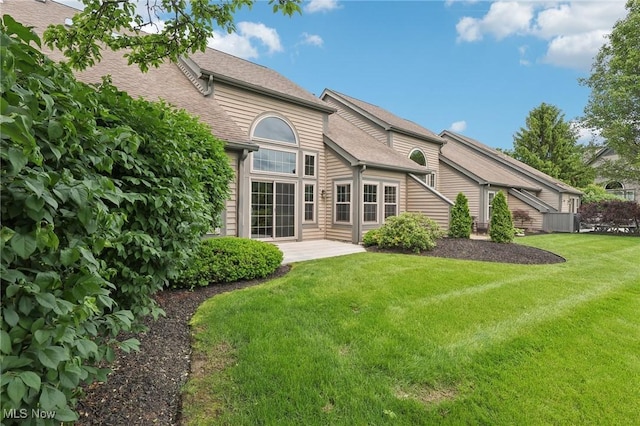 322 N Bayshore Dr Unit 3, Columbiana, OH 44408 - back of house with a yard, roof with shingles, and a patio area