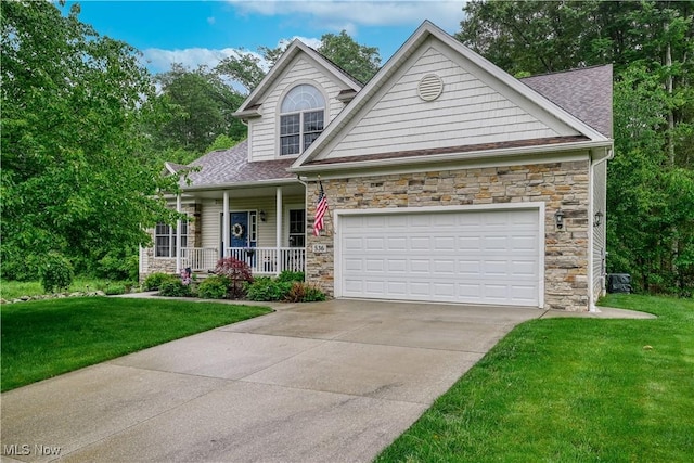 536 Silver Creek Dr, Doylestown, OH 44230 - view of front of house featuring stone siding, covered porch, a front lawn, and driveway