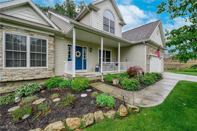 536 Silver Creek Dr, Doylestown, OH 44230 - view of front of home with stone siding, covered porch, a garage, a shingled roof, and driveway