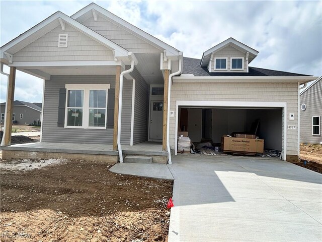 8937 Camden Rd NW, Massillon, OH 44646 - view of front of property featuring driveway, a garage, and a porch