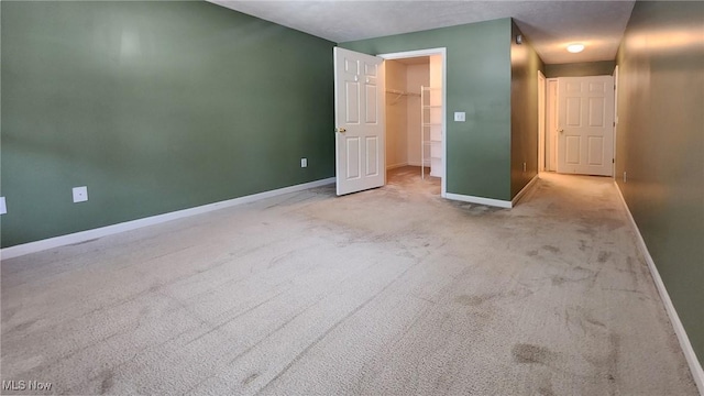 28360 Center Ridge Rd Unit 218, Westlake, OH 44145 - unfurnished bedroom featuring baseboards, a spacious closet, and carpet floors