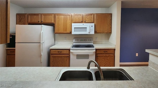28360 Center Ridge Rd Unit 218, Westlake, OH 44145 - kitchen with white appliances, a sink, light countertops, and brown cabinetry