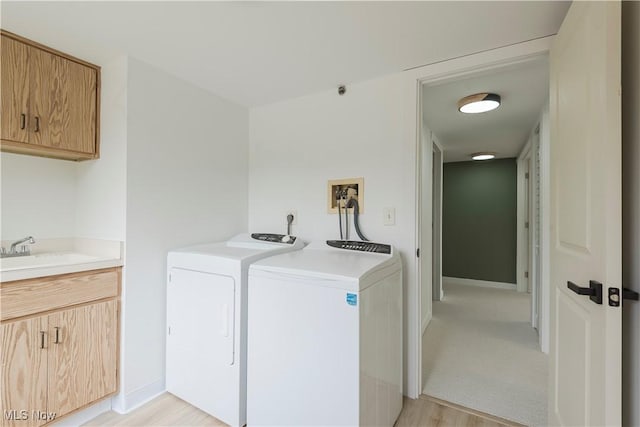 100 Fox Hollow Dr Unit 302, Mayfield Heights, OH 44124 - laundry area with washer and clothes dryer, cabinet space, light wood finished floors, and baseboards