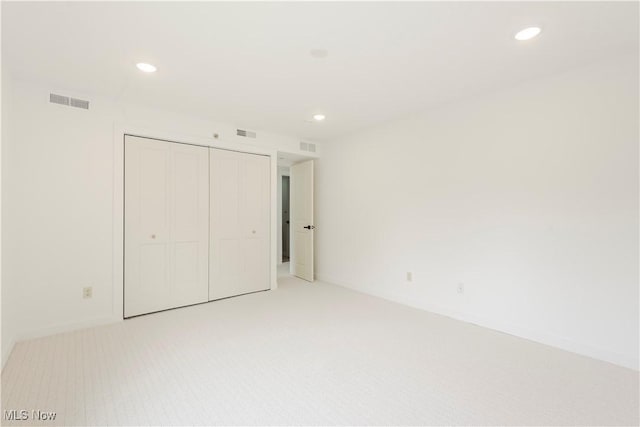 100 Fox Hollow Dr Unit 302, Mayfield Heights, OH 44124 - unfurnished bedroom with light colored carpet, recessed lighting, a closet, and baseboards