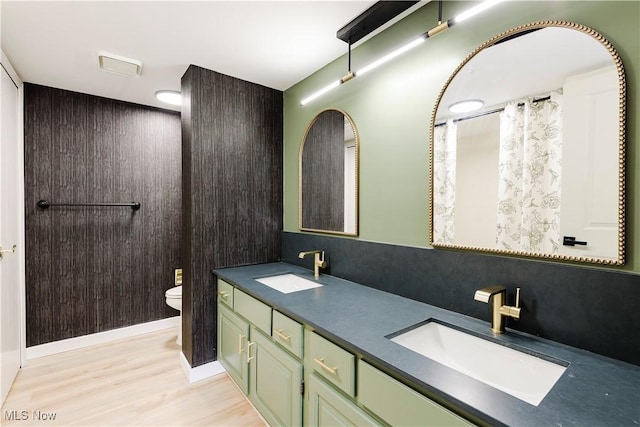 100 Fox Hollow Dr Unit 302, Mayfield Heights, OH 44124 - bathroom featuring toilet, double vanity, and wood finished floors