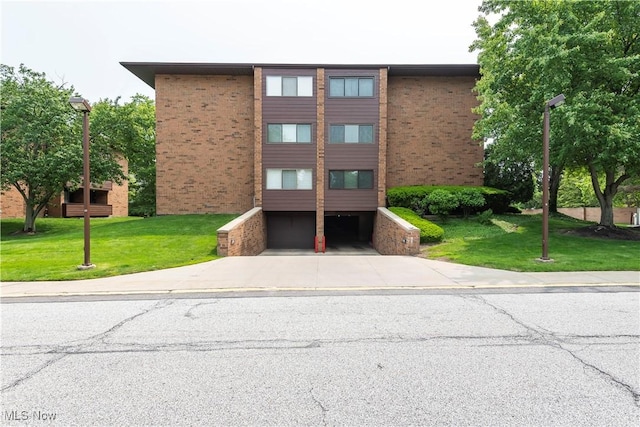 100 Fox Hollow Dr Unit 302, Mayfield Heights, OH 44124 - view of property with a garage and driveway