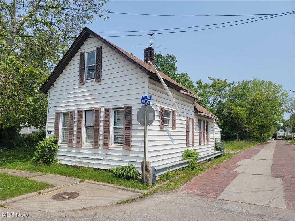 3651 E 50th St, Cleveland, OH 44105 - view of side of home featuring a chimney