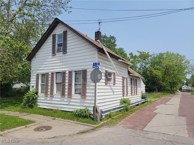 3651 E 50th St, Cleveland, OH 44105 - view of side of home featuring a chimney