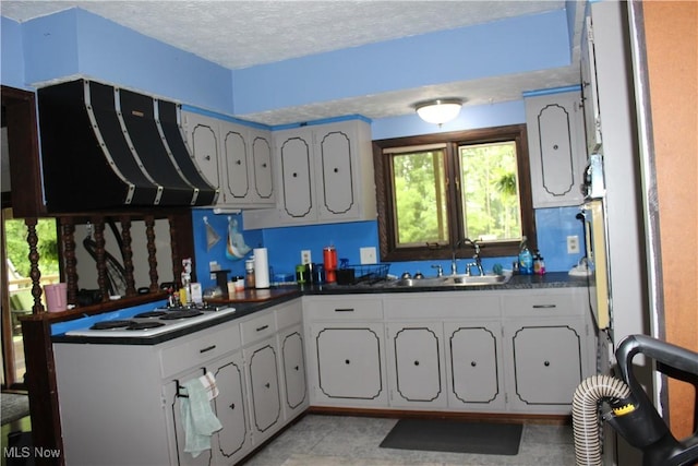666 E Windsor Rd, Orwell, OH 44076 - kitchen with a sink, exhaust hood, dark countertops, white cooktop, and a textured ceiling