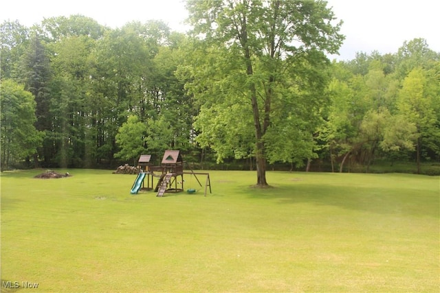 666 E Windsor Rd, Orwell, OH 44076 - view of green lawn featuring a playground