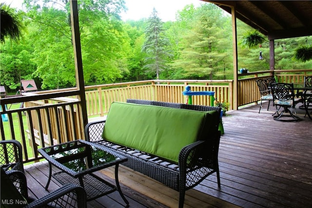 666 E Windsor Rd, Orwell, OH 44076 - wooden deck featuring outdoor dining space and a view of trees
