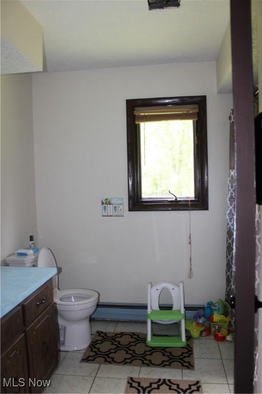 666 E Windsor Rd, Orwell, OH 44076 - full bathroom with toilet, vanity, and tile patterned floors