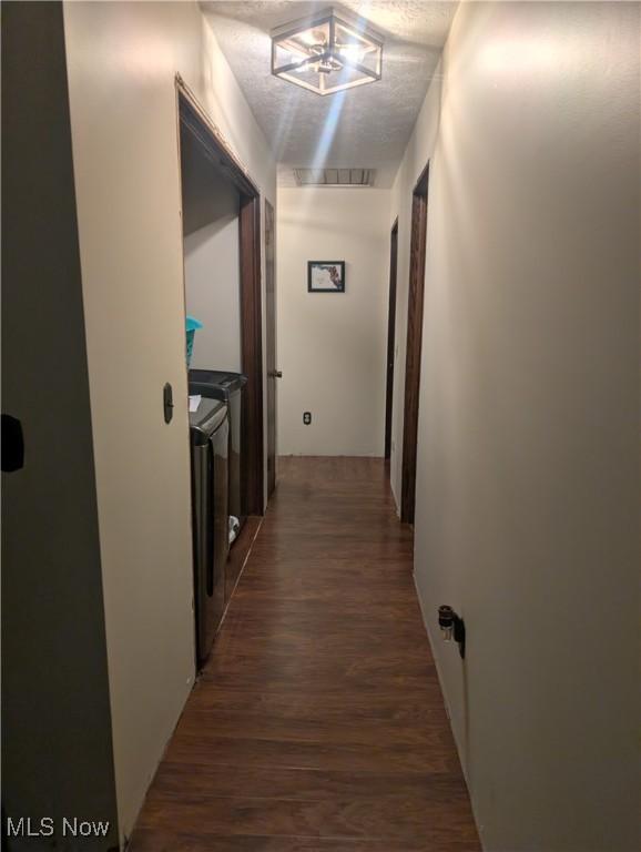 666 E Windsor Rd, Orwell, OH 44076 - corridor with separate washer and dryer and wood finished floors
