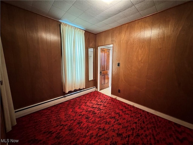 99 W Martin St, East Palestine, OH 44413 - carpeted empty room with a baseboard heating unit and wood walls