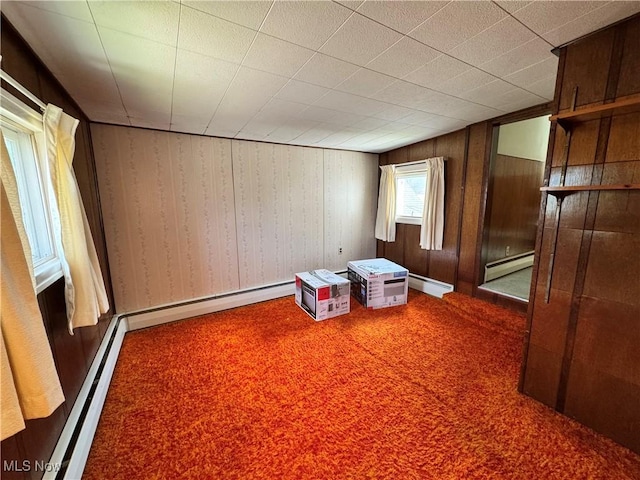 99 W Martin St, East Palestine, OH 44413 - unfurnished room featuring carpet, a baseboard radiator, and wooden walls