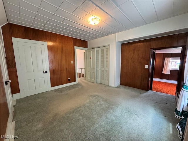 99 W Martin St, East Palestine, OH 44413 - unfurnished bedroom featuring wooden walls, carpet flooring, and baseboards