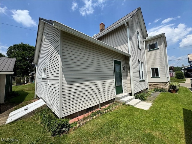 99 W Martin St, East Palestine, OH 44413 - view of side of property featuring entry steps, a lawn, and a chimney
