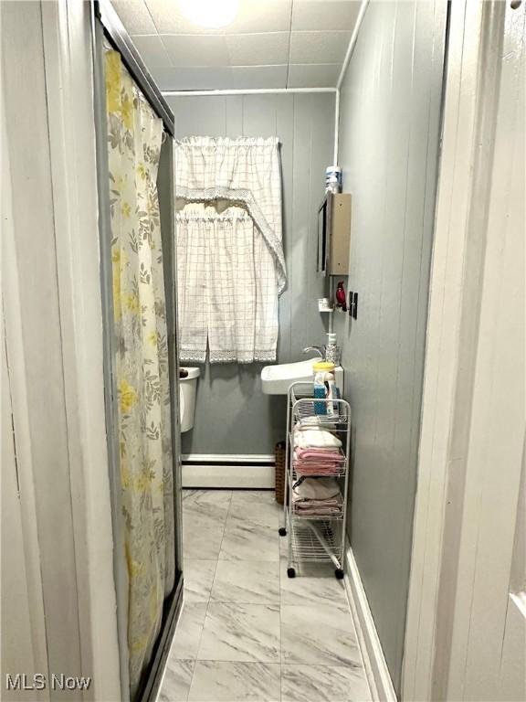 99 W Martin St, East Palestine, OH 44413 - bathroom featuring a baseboard radiator, marble finish floors, and a stall shower
