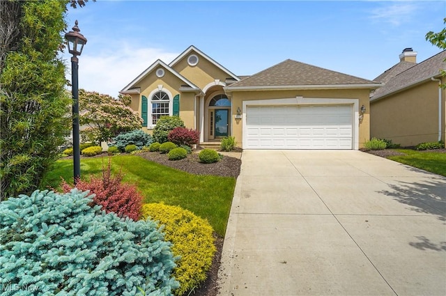 1983 Fox Trace Trl, Cuyahoga Falls, OH 44223 - view of front of property featuring an attached garage, concrete driveway, stucco siding, and a front yard