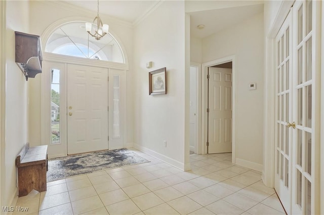 1983 Fox Trace Trl, Cuyahoga Falls, OH 44223 - entrance foyer featuring a chandelier, light tile patterned floors, ornamental molding, and baseboards