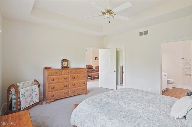 1983 Fox Trace Trl, Cuyahoga Falls, OH 44223 - bedroom with a raised ceiling, ensuite bath, a ceiling fan, and carpet flooring