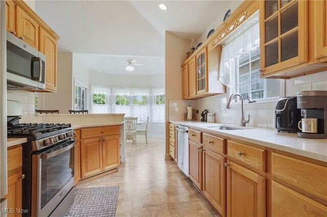 1983 Fox Trace Trl, Cuyahoga Falls, OH 44223 - kitchen featuring stainless steel appliances, a sink, ceiling fan, decorative backsplash, and light countertops