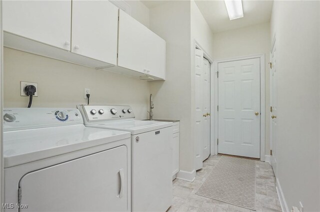 1983 Fox Trace Trl, Cuyahoga Falls, OH 44223 - laundry area with cabinet space, washing machine and clothes dryer, and baseboards
