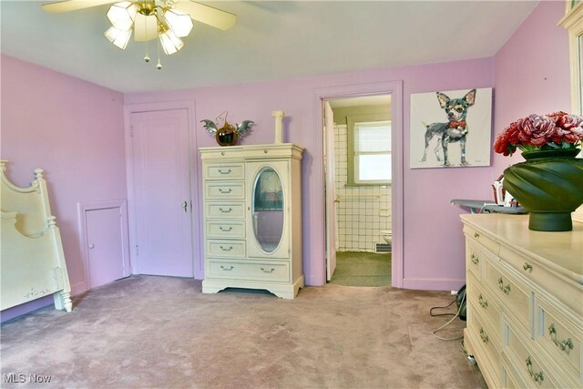 3053 E Market St, Warren, OH 44483 - bedroom with light carpet, ensuite bath, and a ceiling fan