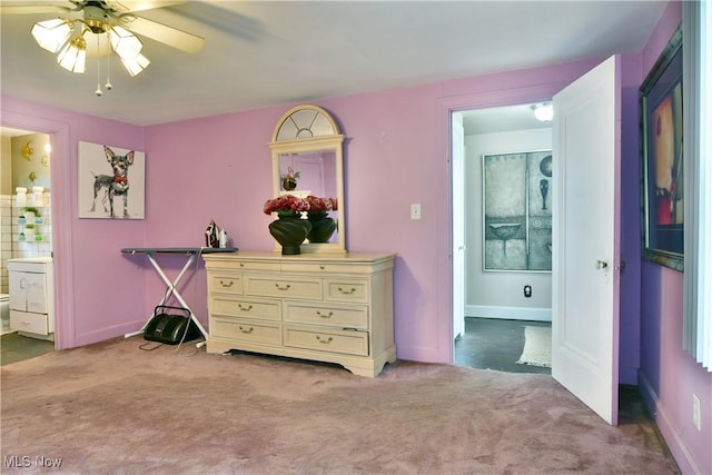 3053 E Market St, Warren, OH 44483 - bedroom featuring light carpet, connected bathroom, baseboards, and ceiling fan