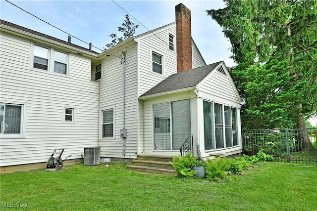 3053 E Market St, Warren, OH 44483 - back of property featuring a sunroom, entry steps, and a chimney