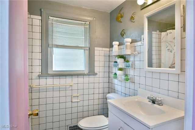 3053 E Market St, Warren, OH 44483 - bathroom with tile walls, vanity, and toilet