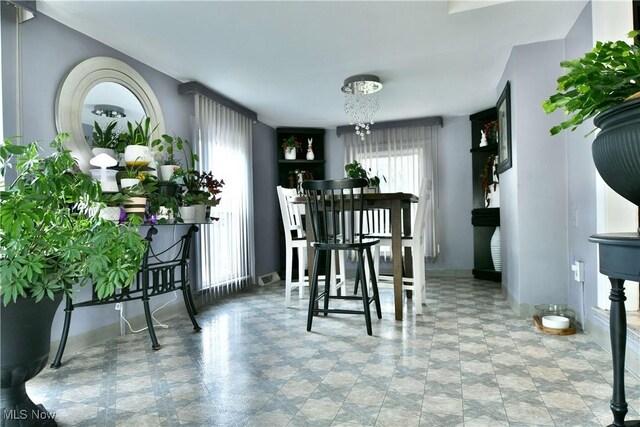 3053 E Market St, Warren, OH 44483 - dining area featuring a chandelier and baseboards