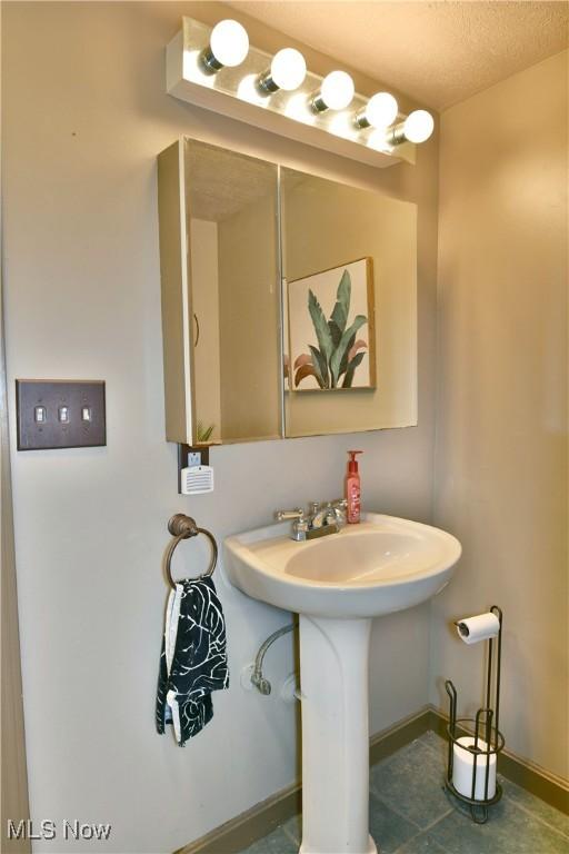 3053 E Market St, Warren, OH 44483 - bathroom with a sink and baseboards