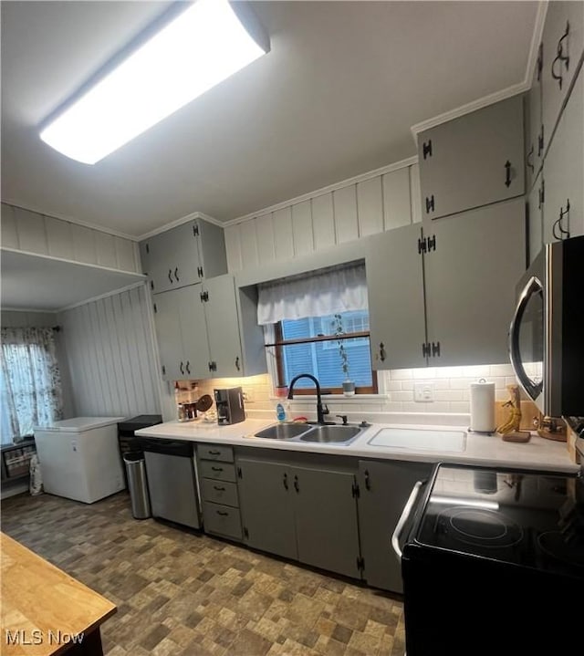 803 N 7th St, Cambridge, OH 43725 - kitchen featuring appliances with stainless steel finishes, a sink, decorative backsplash, healthy amount of natural light, and crown molding