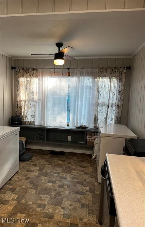 803 N 7th St, Cambridge, OH 43725 - dining space featuring ceiling fan and wood walls