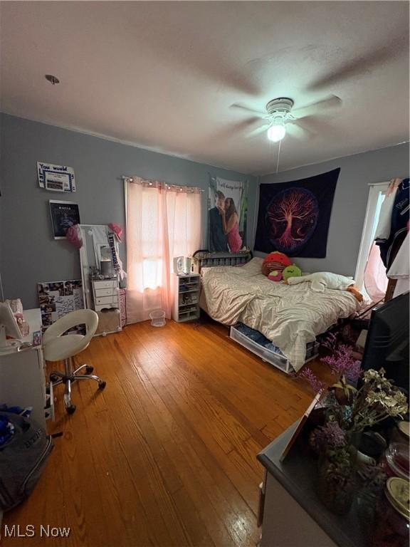 803 N 7th St, Cambridge, OH 43725 - bedroom with wood finished floors and a ceiling fan