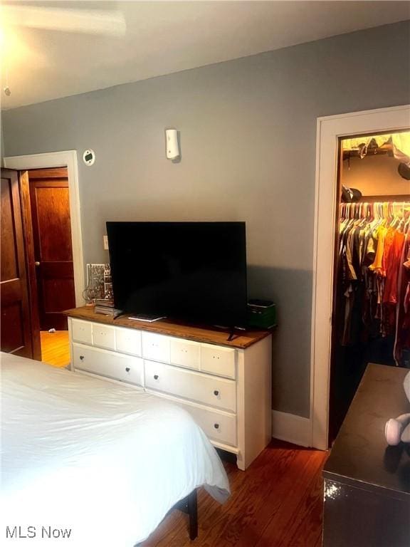 803 N 7th St, Cambridge, OH 43725 - bedroom featuring wood finished floors, a spacious closet, a closet, and baseboards