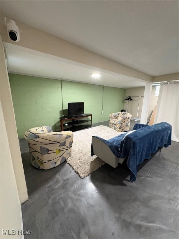 803 N 7th St, Cambridge, OH 43725 - bedroom featuring concrete block wall and finished concrete floors
