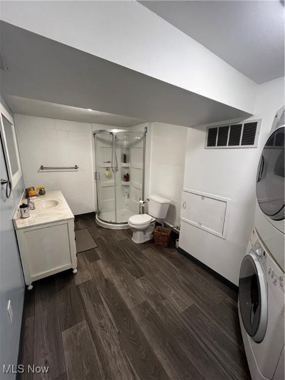 803 N 7th St, Cambridge, OH 43725 - washroom with stacked washing machine and dryer and dark wood-style floors
