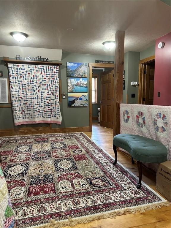 51001 Run Rd, Beallsville, OH 43716 - hall with light wood-type flooring, a textured ceiling, and baseboards