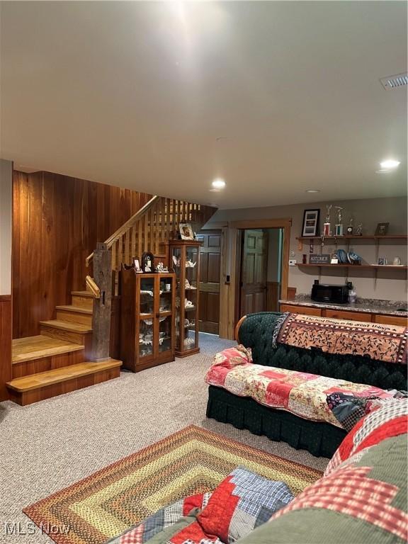 51001 Run Rd, Beallsville, OH 43716 - living area with carpet flooring, stairway, and wood walls