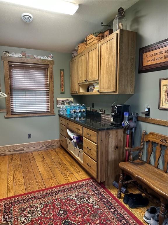 51001 Run Rd, Beallsville, OH 43716 - kitchen with light wood-style flooring, baseboards, and brown cabinets