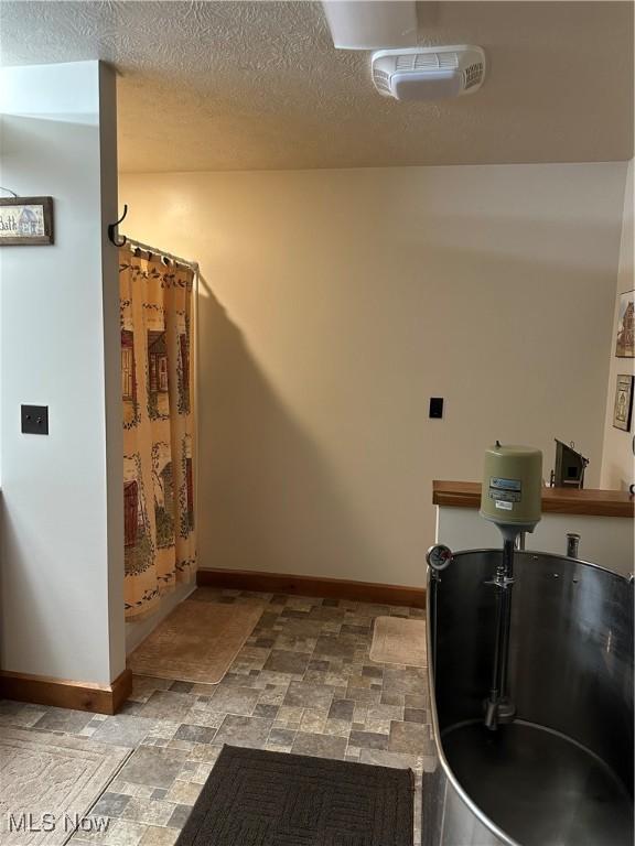 51001 Run Rd, Beallsville, OH 43716 - corridor with baseboards, stone finish floors, and a textured ceiling